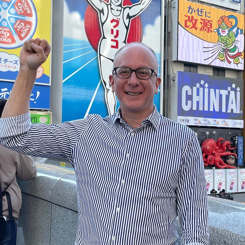 Daniel Hall in Tokyo with fist raised.